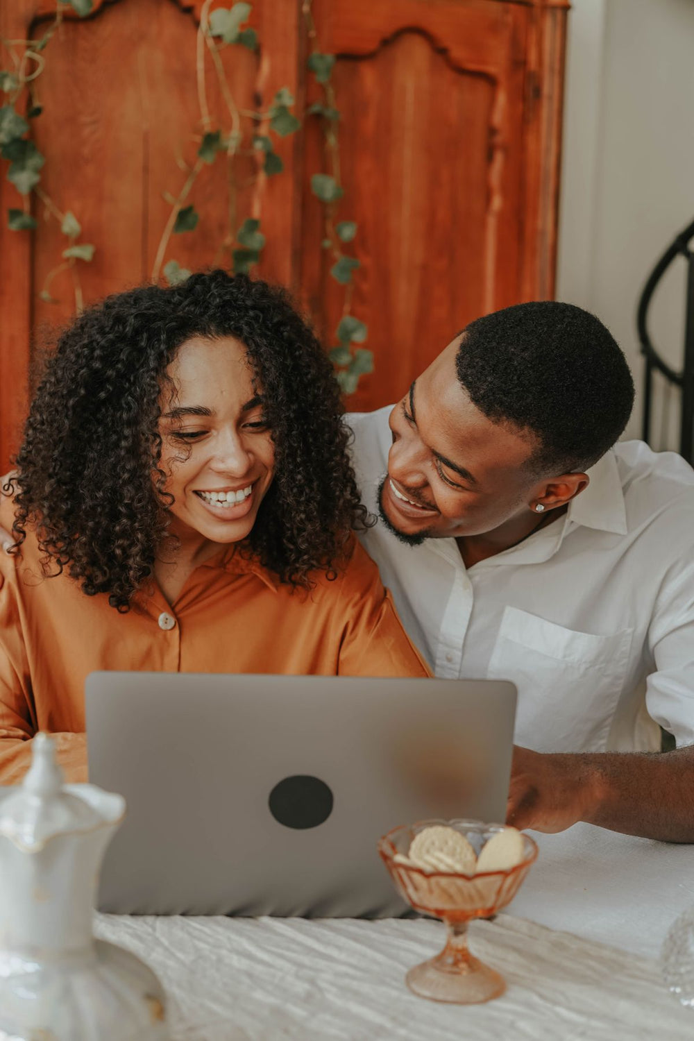 Couple planning monthly payments on a laptop